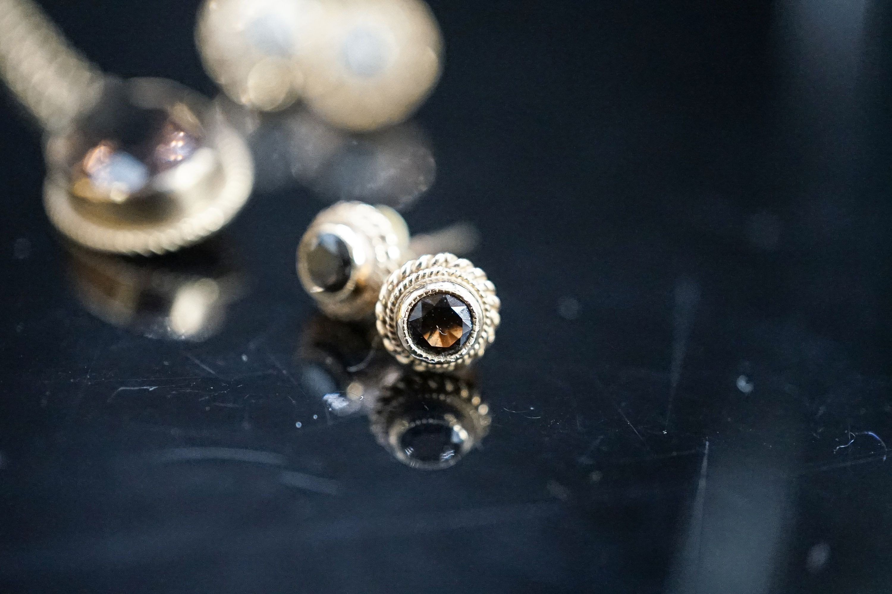 A modern 9ct gold and smoky quartz set pendant on a 9ct chain and two pairs of 9ct earrings, gross 6.2 grams and two other pendants on chains.
